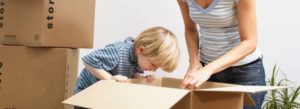 boy peering into empty box, moving house